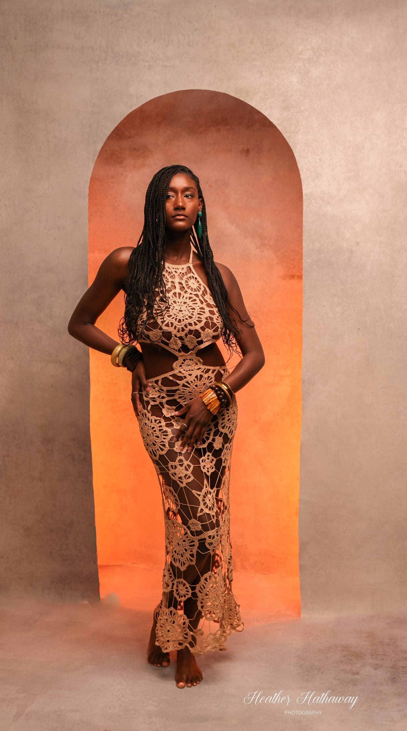 A gorgeous model poses during Imaging 2026 in front of a paper backdrop.
