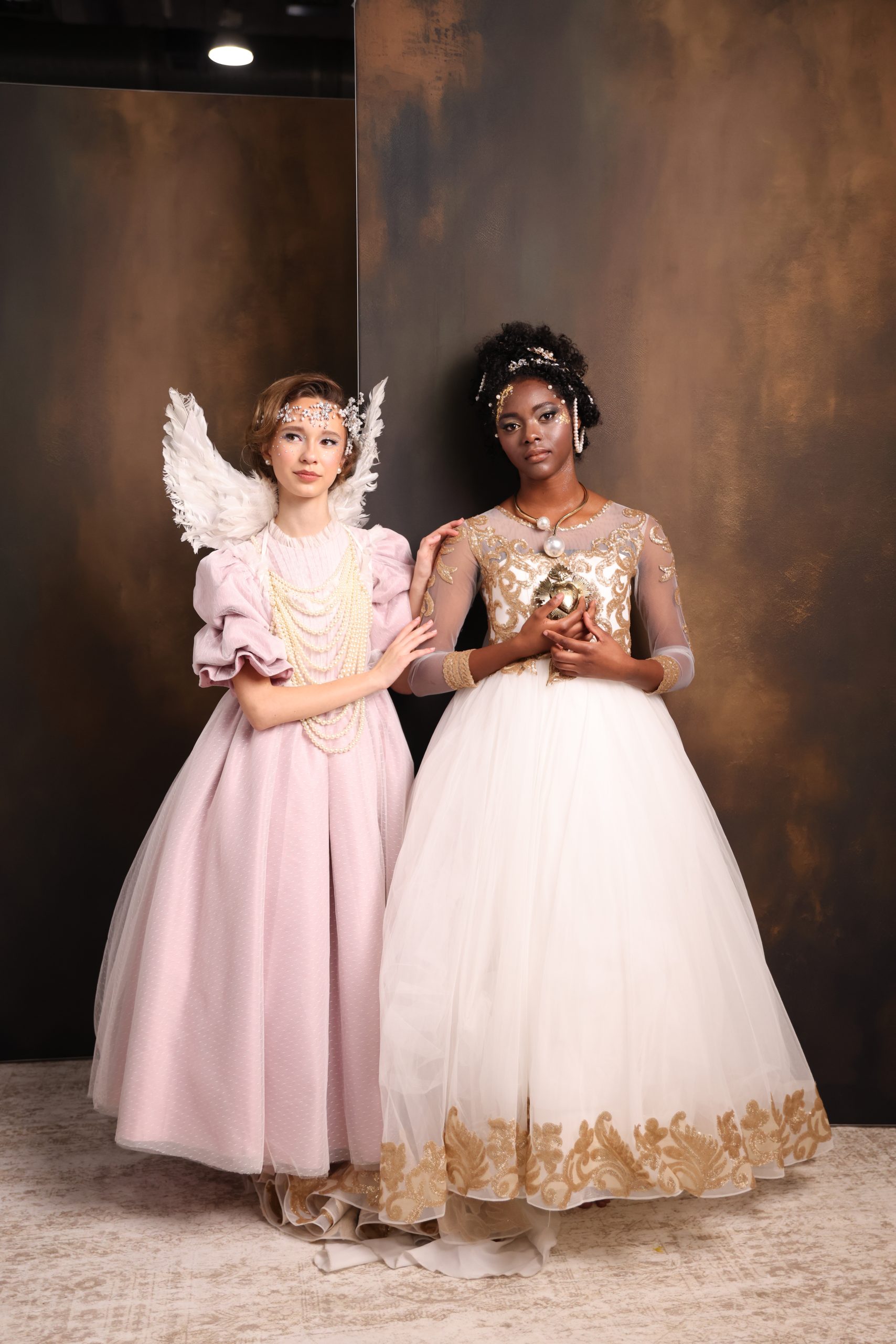 Two teen models pose against a tan & brown backdrop at Imaging 2025.